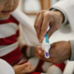 Parent applying fluoride-free toothpaste for kids onto a child’s toothbrush