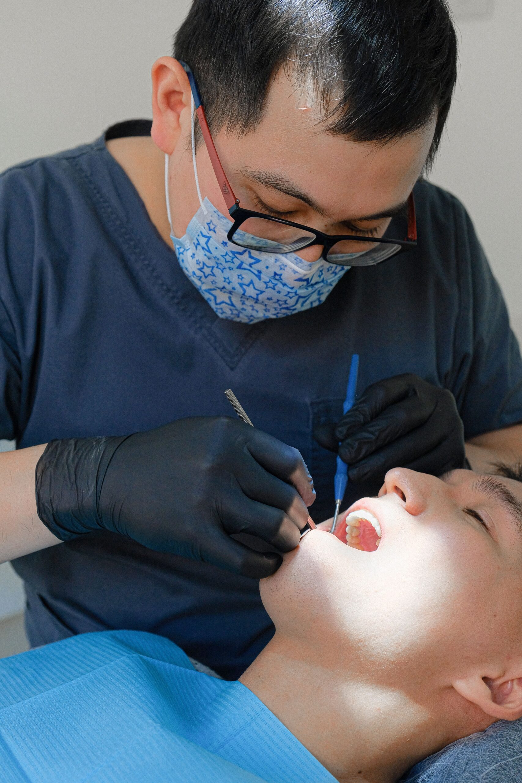 Dentist examining a patient's gums and teeth during a routine oral checkup