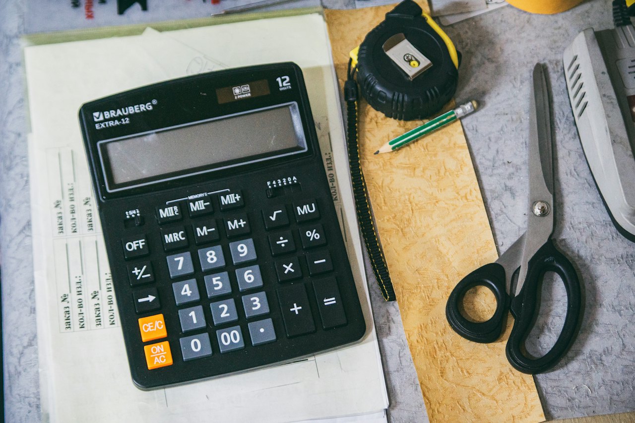 Dental Insurance Annual Maximum: Year-End Guide 2 Calculator and paperwork on a desk, used to work out dental insurance coverage and out-of-pocket costs
