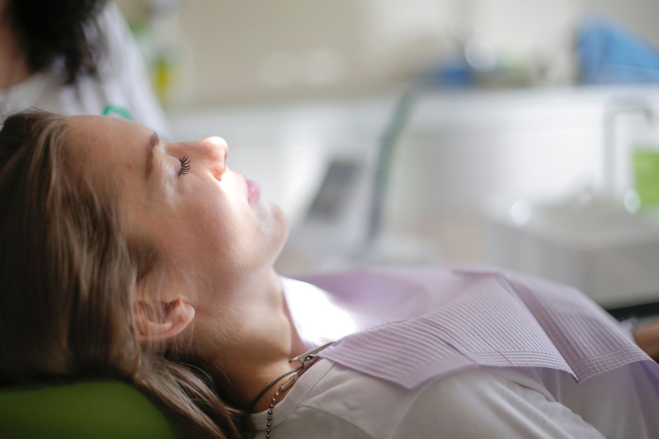 Patient resting in a dental chair during a checkup, a common way to use dental insurance benefits before the year ends